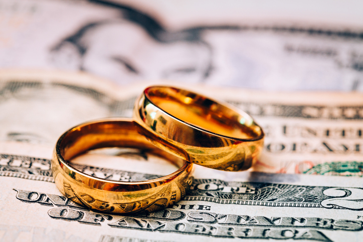 Wedding rings on top of bills