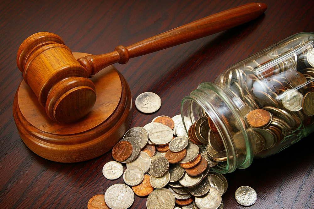 Gavel next to spilled change
