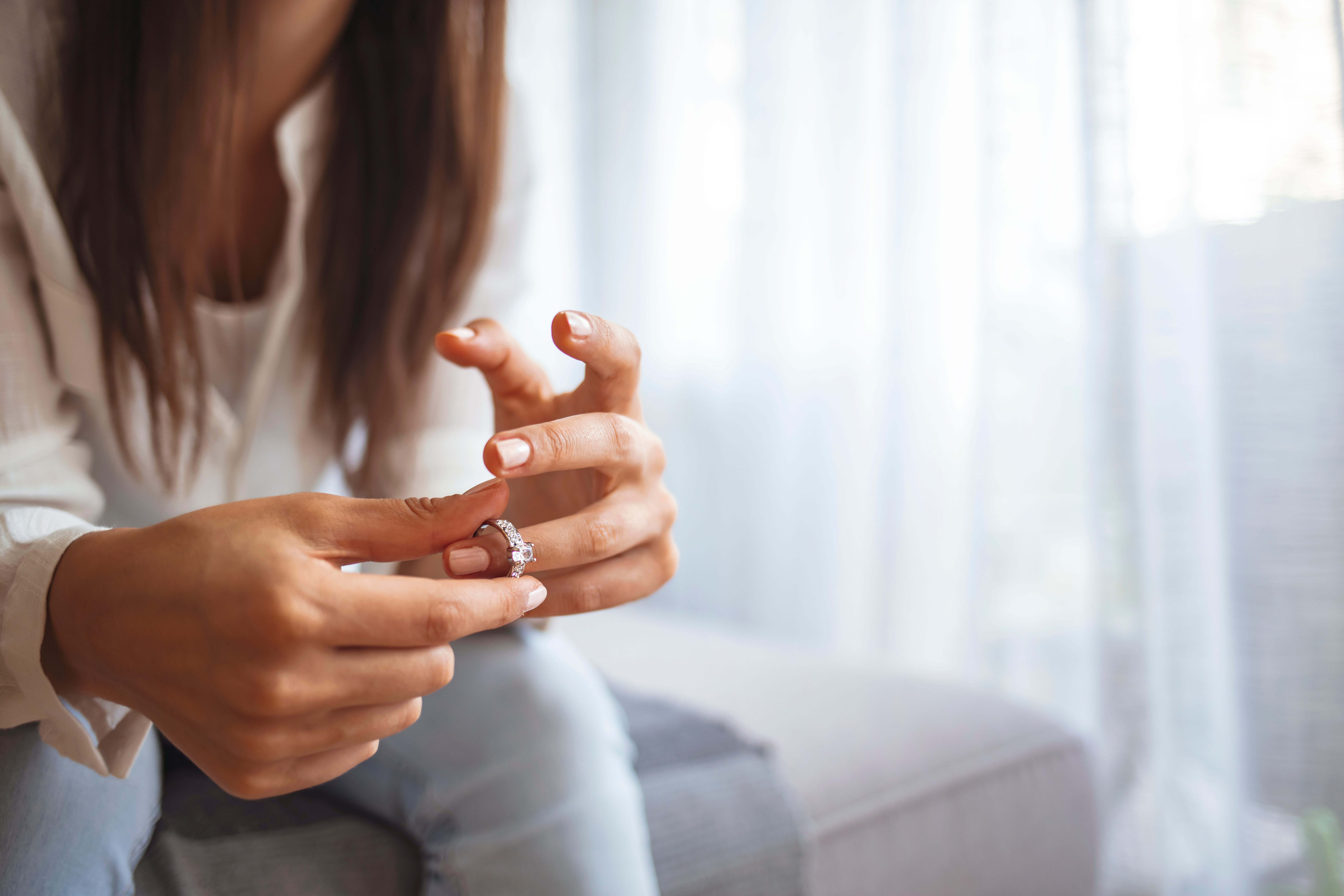 Woman removing wedding ring from her finger